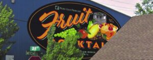 A Pacific Coast Producers building displaying a sign for fruit cocktail.